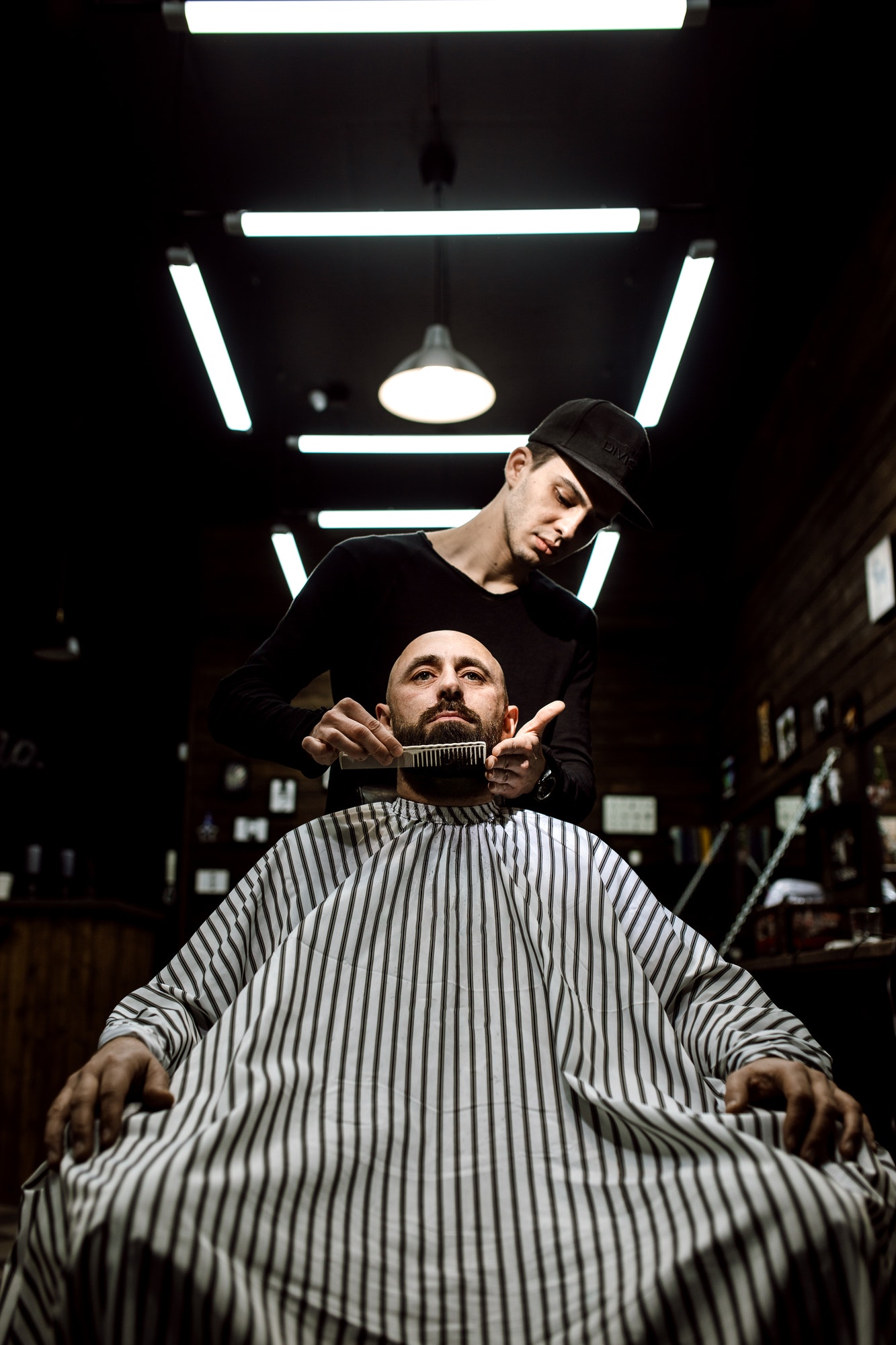 the-stylish-barbershop-the-fashion-barber-tidies-up-beard-of-brutal-man-sitting-in-the-armchair.jpg